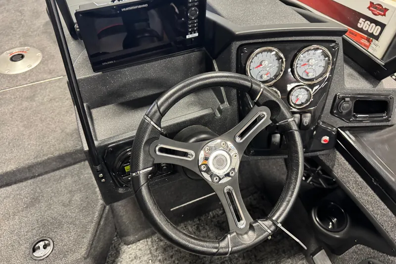 Slide: The Image of 2026 Tracker Targa V-19 Combo boat dashboard with steering wheel and gauges. - 7