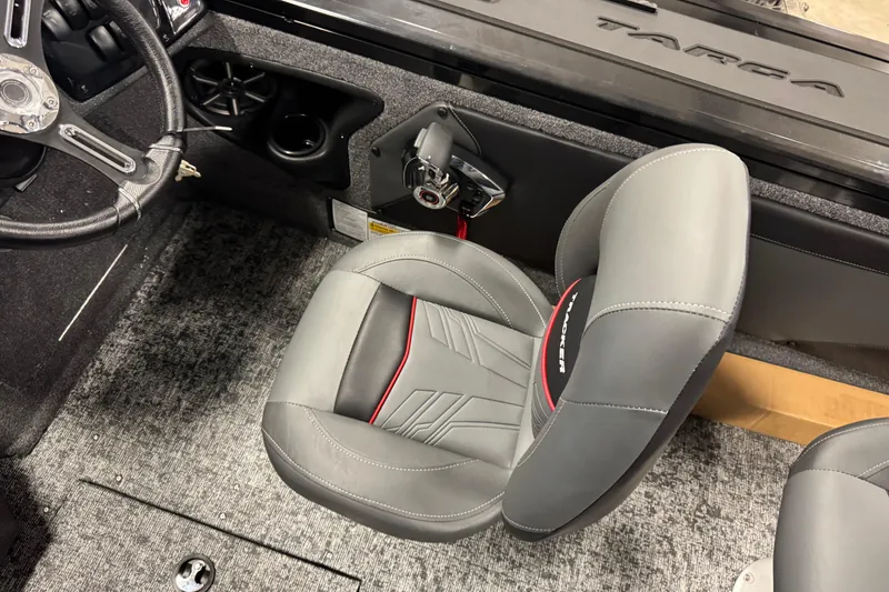 Slide: The Image of 2026 Tracker Targa V-19 Combo boat interior with gray seating and steering wheel. - 8