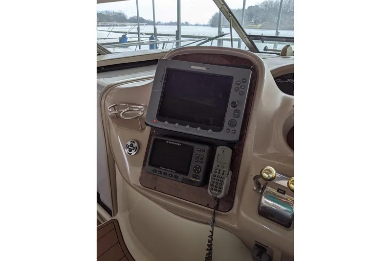 Slide: The Image of Control panel of a 2004 Sea Ray 380 Sundancer boat with navigation equipment. - 12