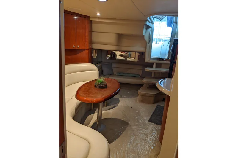 Slide: The Image of Interior of 2004 Sea Ray 380 Sundancer yacht with elegant seating and wooden table. - 14