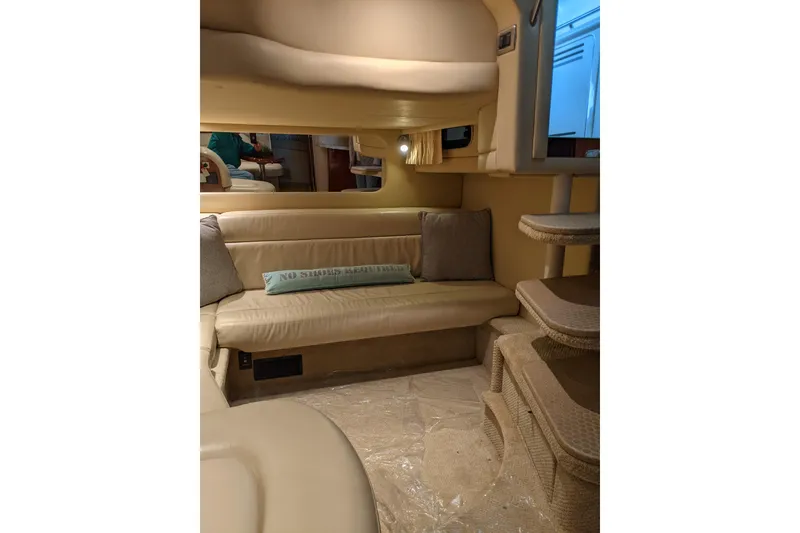 Slide: The Image of Interior of 2004 Sea Ray 380 Sundancer with beige seating and cozy decor. - 19