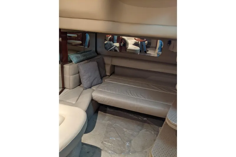 Slide: The Image of 2004 Sea Ray 380 Sundancer interior with beige seating and cushions. - 20