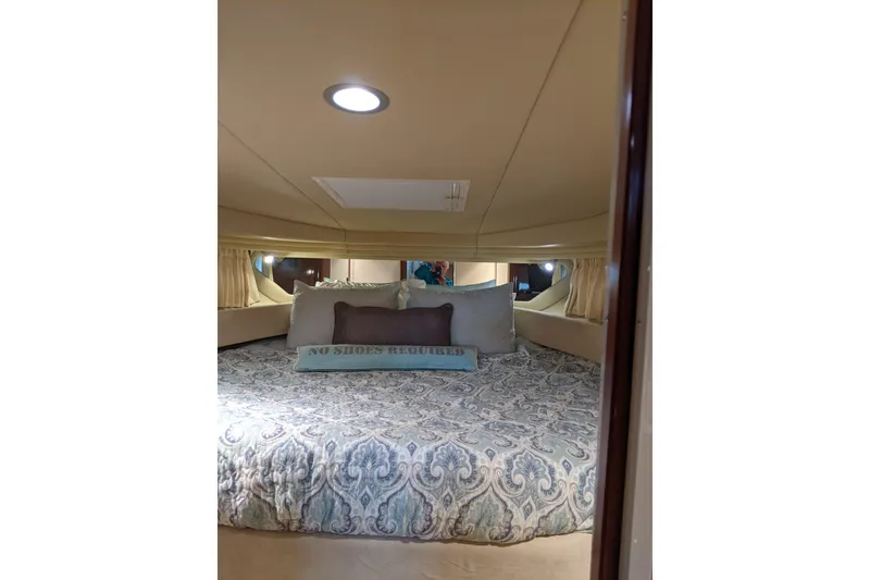 Slide: The Image of Luxurious cabin interior of 2004 Sea Ray 380 Sundancer with elegant bedding. - 21