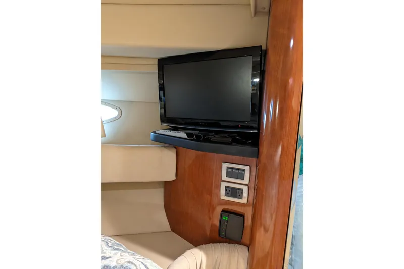 Slide: The Image of Interior of 2004 Sea Ray 380 Sundancer with mounted TV and control panel. - 23