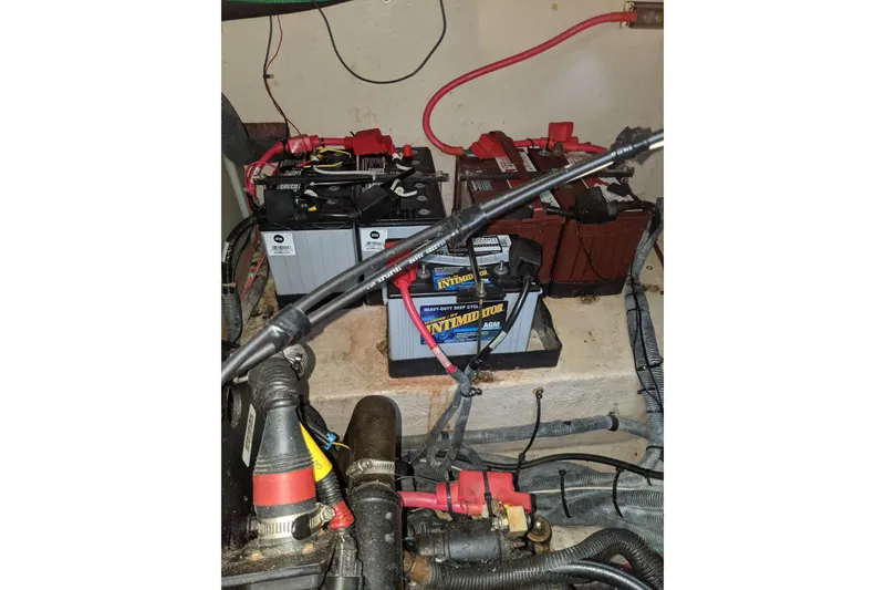 Slide: The Image of Engine compartment of a 2004 Sea Ray 380 Sundancer with multiple marine batteries. - 28