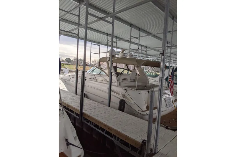 Slide: The Image of 2004 Sea Ray 380 Sundancer docked under a covered marina. - 3