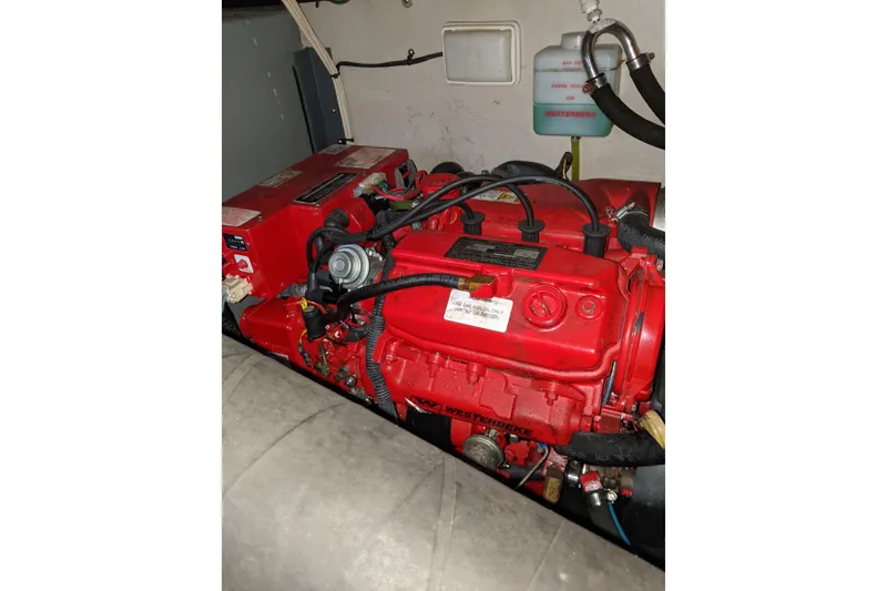 Slide: The Image of Engine compartment of a 2004 Sea Ray 380 Sundancer with red Westerbeke generator. - 37