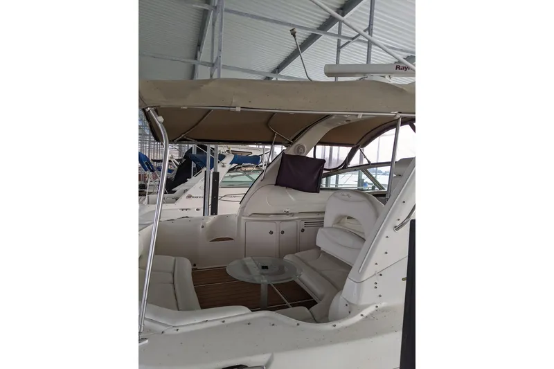 Slide: The Image of 2004 Sea Ray 380 Sundancer interior with seating and canopy in a marina. - 39