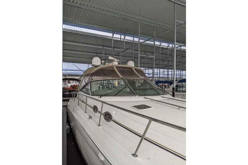 Slide: The Image of 2004 Sea Ray 380 Sundancer yacht docked under a covered marina. - 43