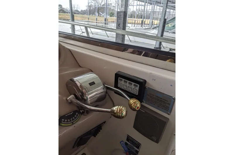 Slide: The Image of Control panel of 2004 Sea Ray 380 Sundancer yacht with throttle and navigation instruments. - 8