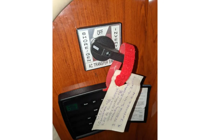 Slide: The Image of AC transfer switch on 2004 Sea Ray 380 Sundancer with handwritten note attached. - 9
