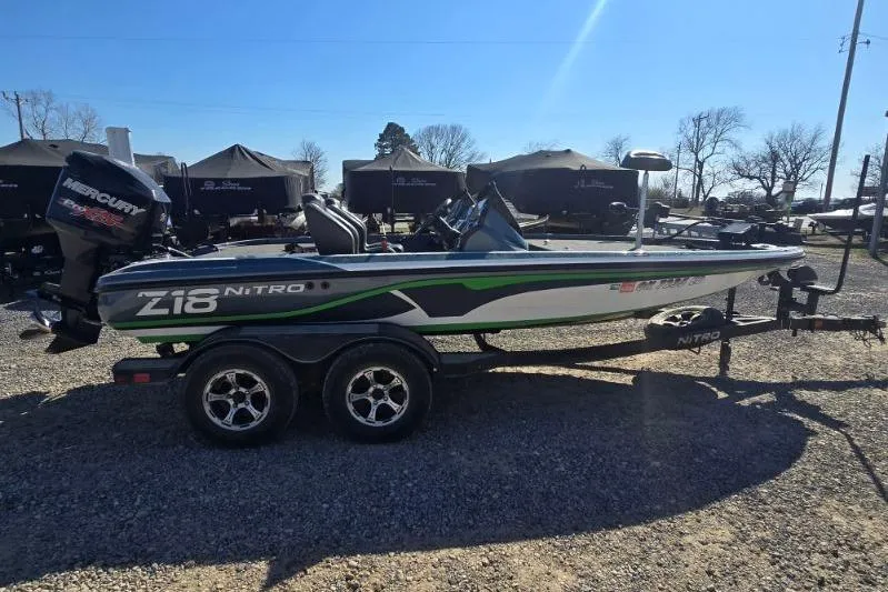 The Image of 2018 Nitro Z18 Tracker boat with Mercury engine on trailer in outdoor setting. - 1