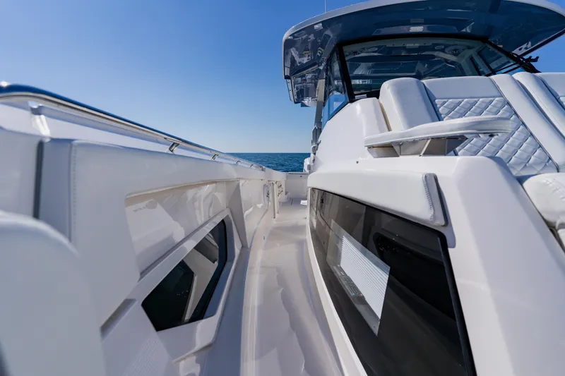 Slide: The Image of 2022 Pursuit S 378 Sport boat, sleek design, ocean view, sunny day. - 17