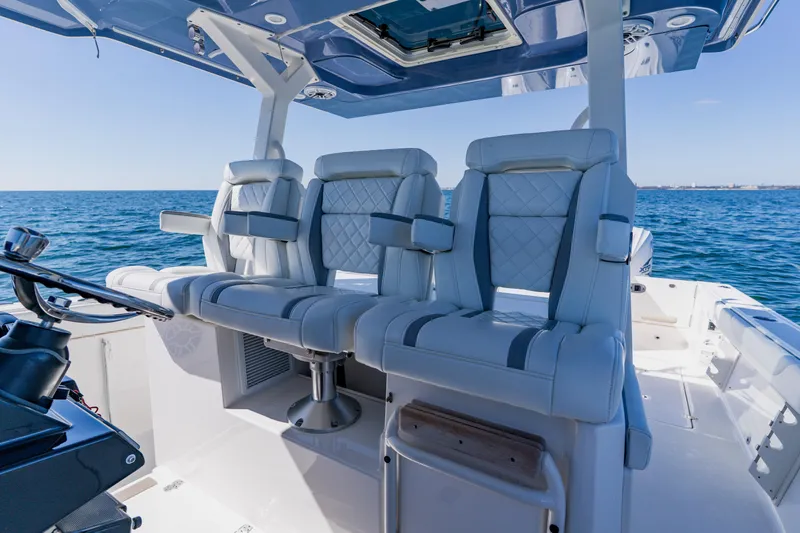 Slide: The Image of Luxury seating on 2022 Pursuit S 378 Sport boat, ocean backdrop. - 20