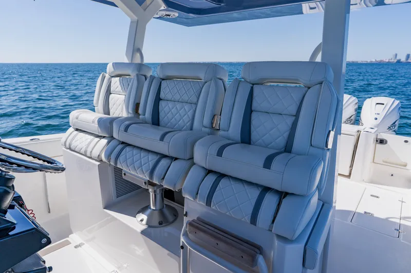 Slide: The Image of Luxurious seating on 2022 Pursuit S 378 Sport boat, ocean backdrop. - 21