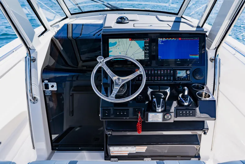 Slide: The Image of 2022 Pursuit S 378 Sport boat helm with advanced navigation and control systems. - 24