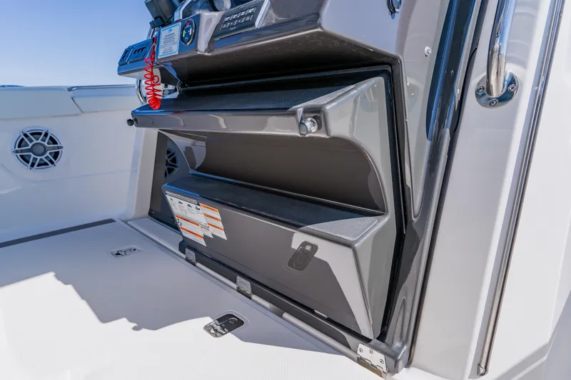 Slide: The Image of 2022 Pursuit S 378 Sport boat interior with storage compartment and control panel. - 26