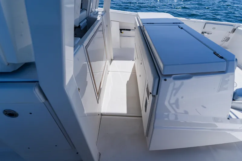 Slide: The Image of 2022 Pursuit S 378 Sport boat interior with sleek cabinetry and ocean view. - 30