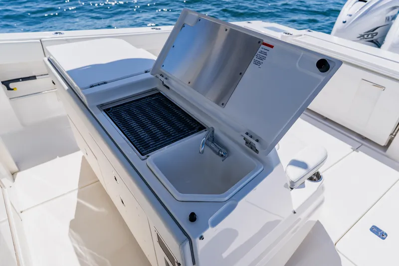 Slide: The Image of 2022 Pursuit S 378 Sport boat with onboard sink and grill setup. - 31