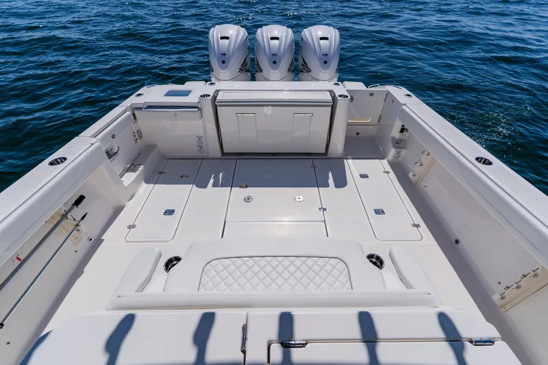 Slide: The Image of 2022 Pursuit S 378 Sport boat deck with triple engines on open water. - 37