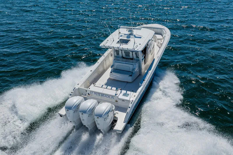 Slide: The Image of 2022 Pursuit S 378 Sport boat cruising on open water, rear view. - 4