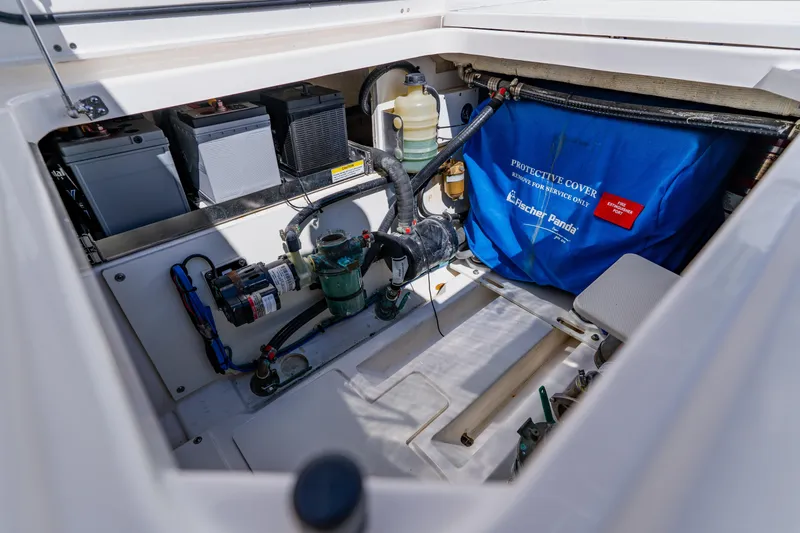 Slide: The Image of 2022 Pursuit S 378 Sport engine compartment with batteries and Fischer Panda generator cover. - 40