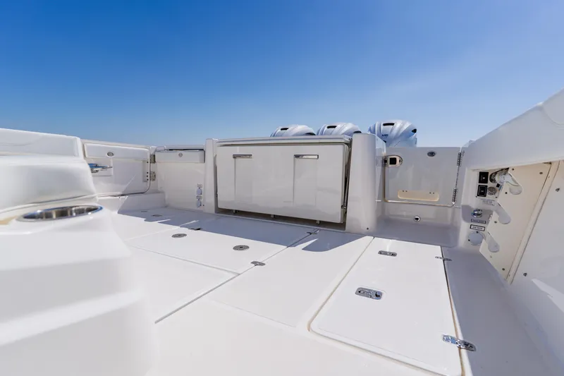 Slide: The Image of 2022 Pursuit S 378 Sport boat deck with storage and engine view. - 42