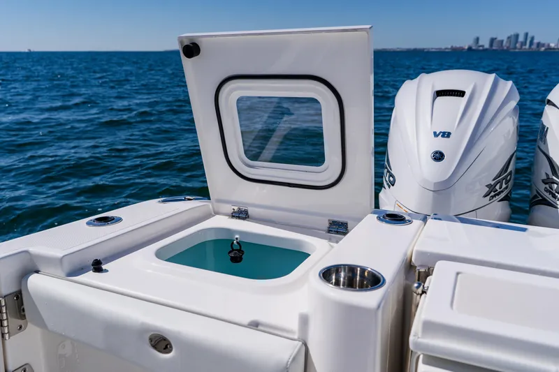 Slide: The Image of 2022 Pursuit S 378 Sport boat with open hatch and powerful V8 engines. - 48