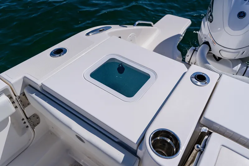 Slide: The Image of 2022 Pursuit S 378 Sport boat deck with engine and storage compartment. - 49