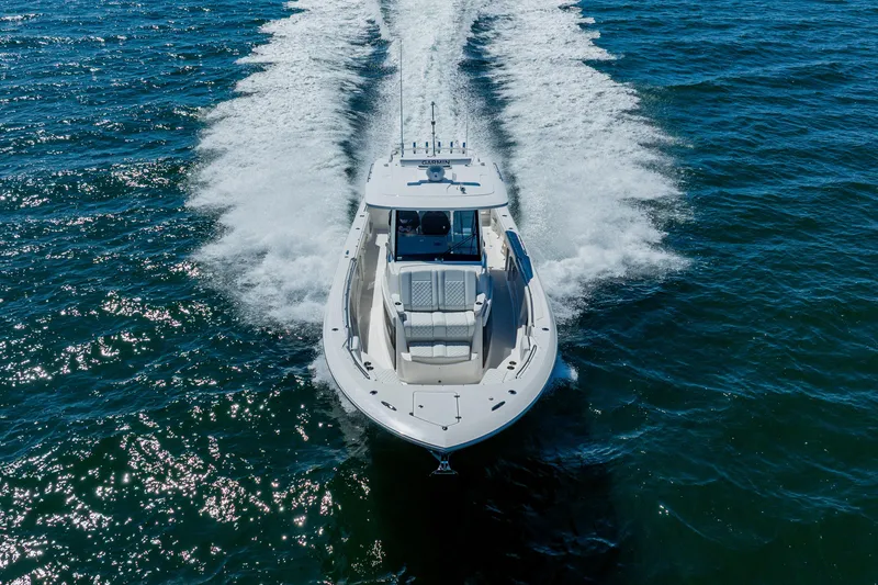 Slide: The Image of 2022 Pursuit S 378 Sport boat cruising on open water, aerial view. - 5