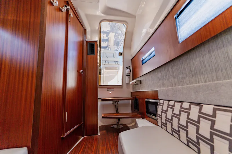 Slide: The Image of Luxurious interior of 2022 Pursuit S 378 Sport boat with wood finishes and seating. - 53