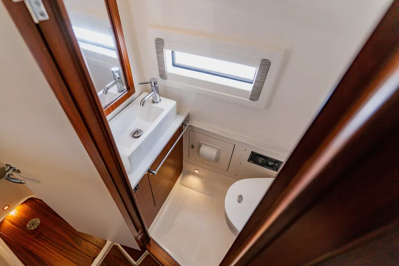 Slide: The Image of 2022 Pursuit S 378 Sport boat bathroom with sink, toilet, and window. - 54
