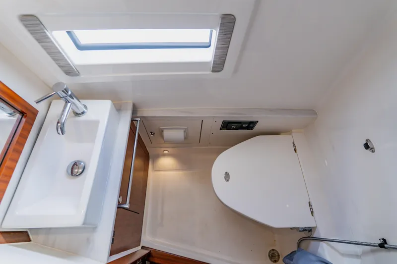 Slide: The Image of 2022 Pursuit S 378 Sport boat bathroom with sink, toilet, and window. - 55