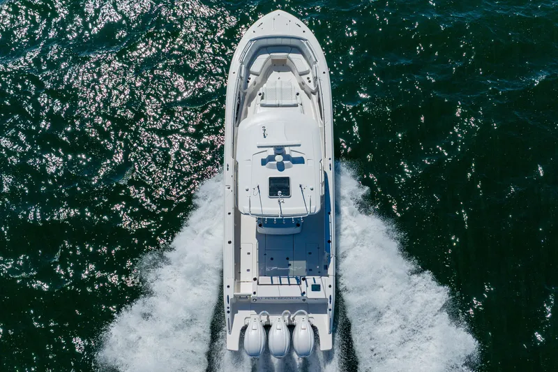 Slide: The Image of 2022 Pursuit S 378 Sport boat cruising on open water, aerial view. - 6