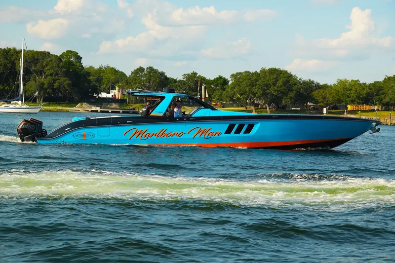 The Image of 2024 Cigarette 59' Tirranna speedboat on water, vibrant blue with "Marlboro Man" text. - 1