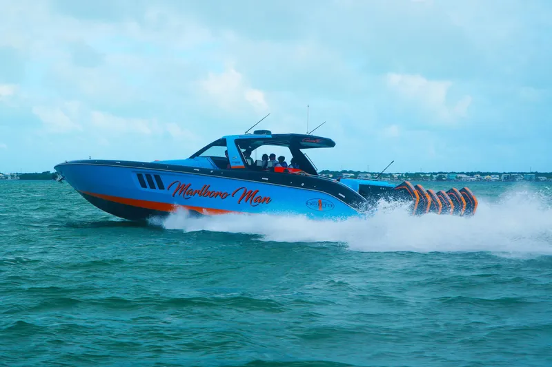 Slide: The Image of 2024 Cigarette 59' Tirranna speedboat cruising on open water, showcasing sleek design and power. - 3