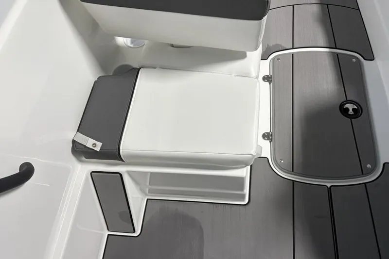 Slide: The Image of 2026 Tahoe T16 boat interior with white seating and gray flooring. - 12
