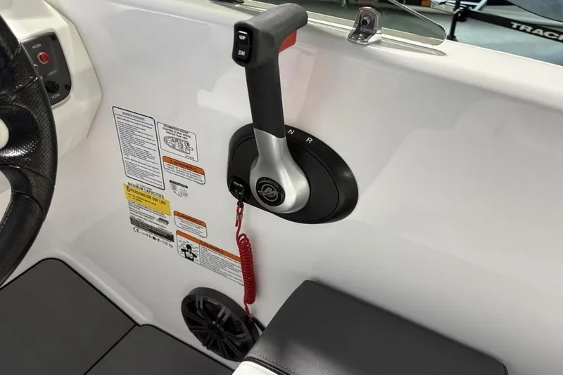 Slide: The Image of Control panel of a 2026 Tahoe T16 boat with throttle and safety features. - 16