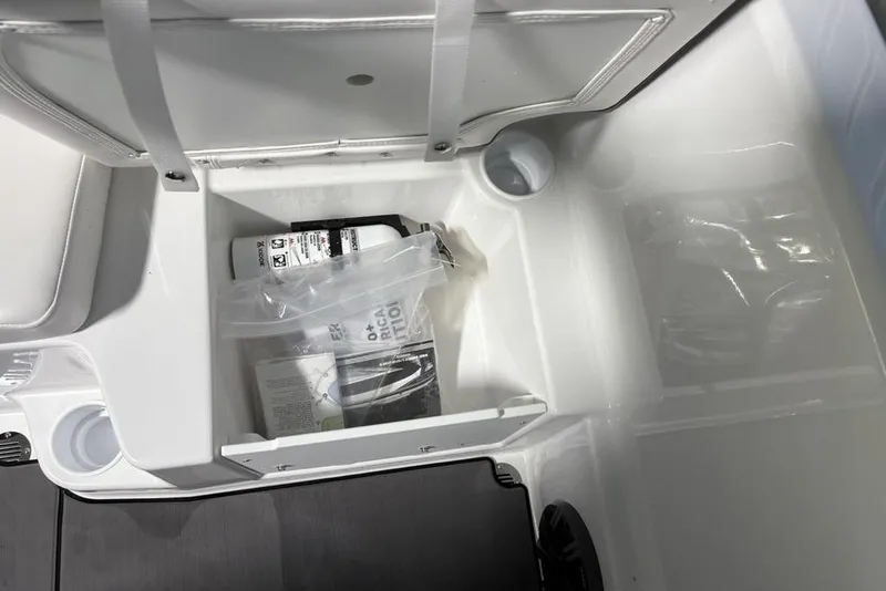Slide: The Image of Storage compartment in a 2026 Tahoe T16 boat, containing safety equipment and accessories. - 17