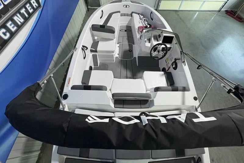 Slide: The Image of 2026 Tahoe T16 boat interior with seating and steering wheel, displayed in a showroom. - 19
