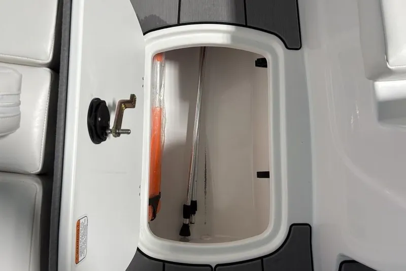 Slide: The Image of Open storage compartment in 2026 Tahoe T16 boat, featuring sleek white and black design. - 6