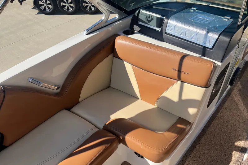 Slide: The Image of 2016 MasterCraft X23 boat interior with tan and cream seating. - 11