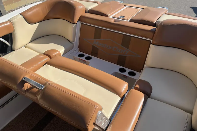 Slide: The Image of 2016 MasterCraft X23 boat interior with tan and cream seating. - 17