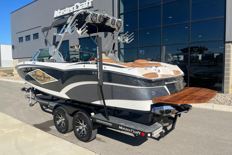 Slide: The Image of 2016 MasterCraft X23 boat on trailer outside dealership, featuring sleek design and modern amenities. - 4