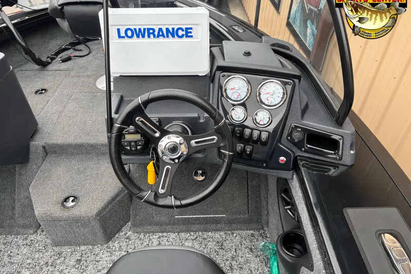 Slide: The Image of 2026 Tracker Targa V-18 WT boat dashboard with Lowrance Elite system and steering wheel. - 7