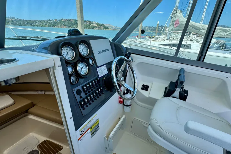 Slide: The Image of 2013 Seaswirl Striper 2601 Walkaround O/B helm with Garmin navigation, overlooking marina. - 2