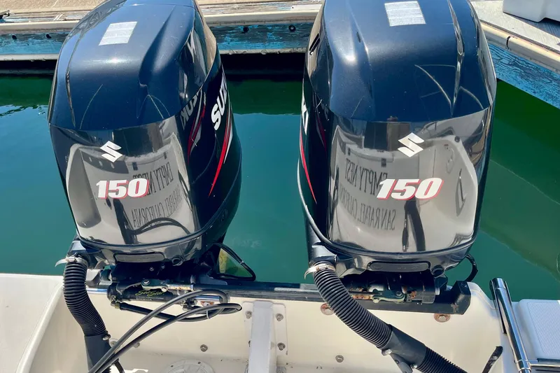Slide: The Image of Twin Suzuki 150 outboard engines on a 2013 Seaswirl Striper 2601 Walkaround boat. - 3