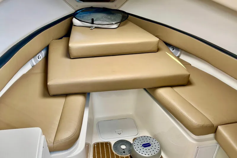 Slide: The Image of 2013 Seaswirl Striper 2601 Walkaround O/B cabin interior with beige cushions. - 5