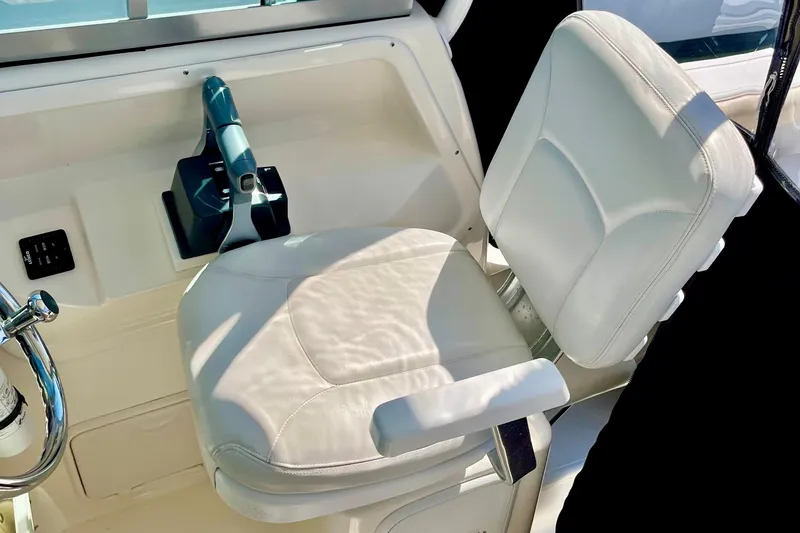 Slide: The Image of Captain's seat and controls of a 2013 Seaswirl Striper 2601 Walkaround O/B boat. - 8
