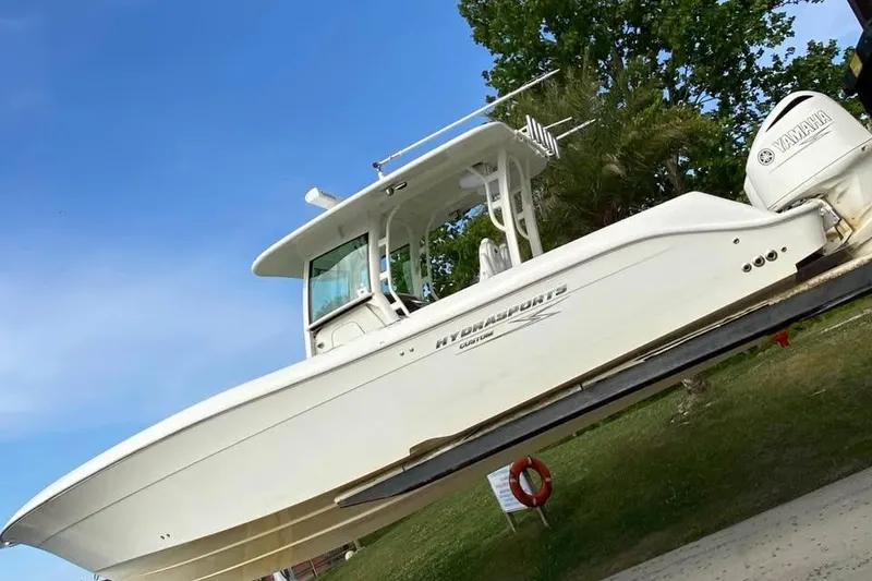 The Image of 2017 Hydra-Sports 3400 CC boat docked under wooden shelter at night. - 0
